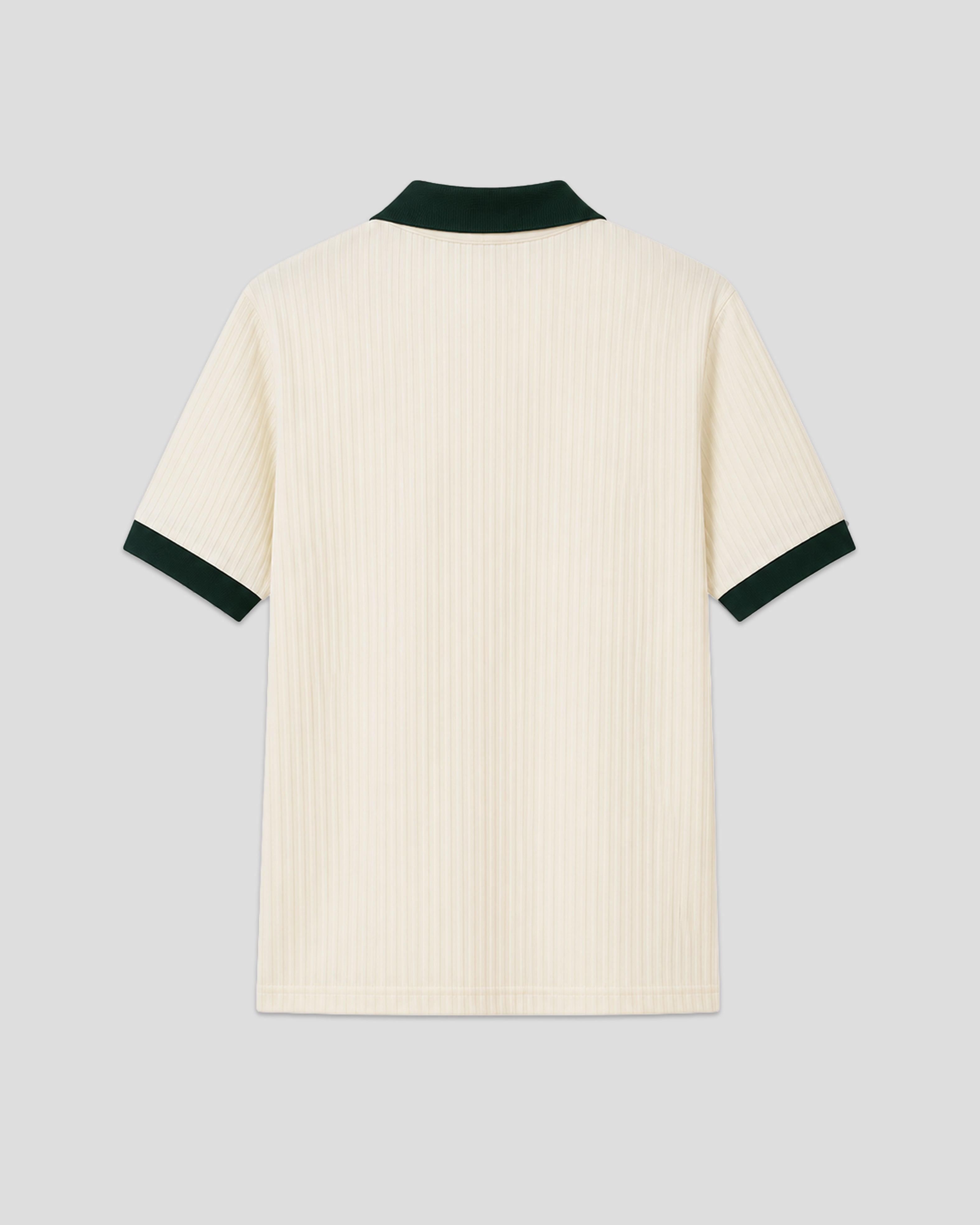 Cream-colored émilio pique shirt with green trim on a light gray background