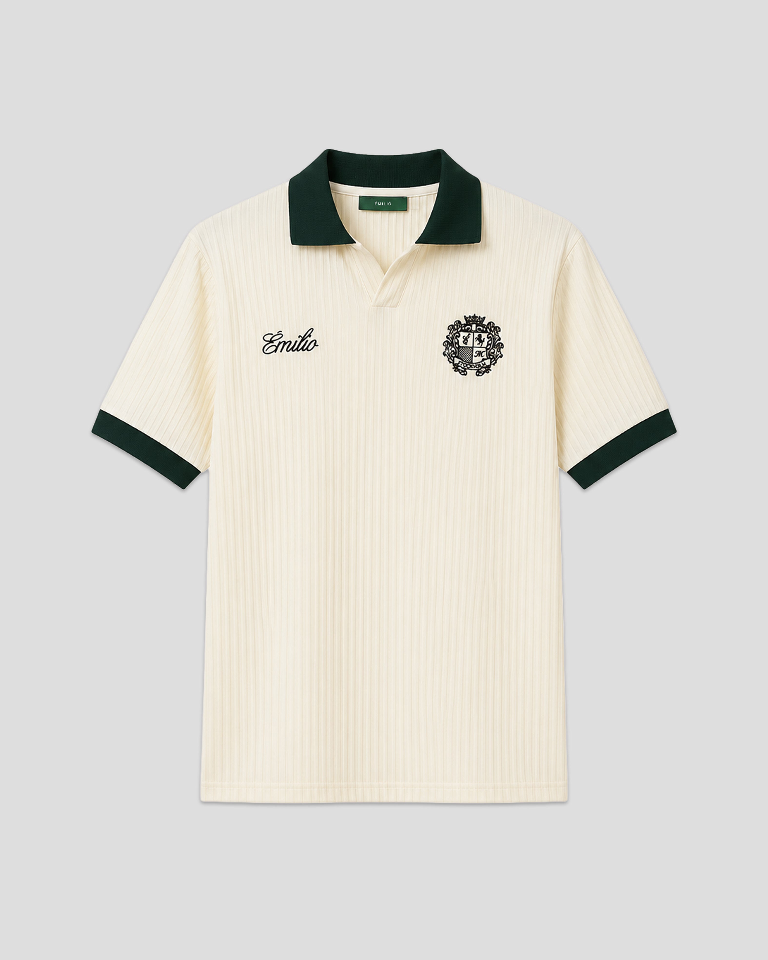 Cream-colored émilio pique shirt with green trim on a light gray background