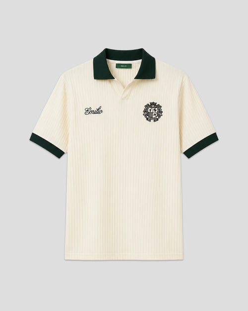 Cream-colored émilio pique shirt with green trim on a light gray background