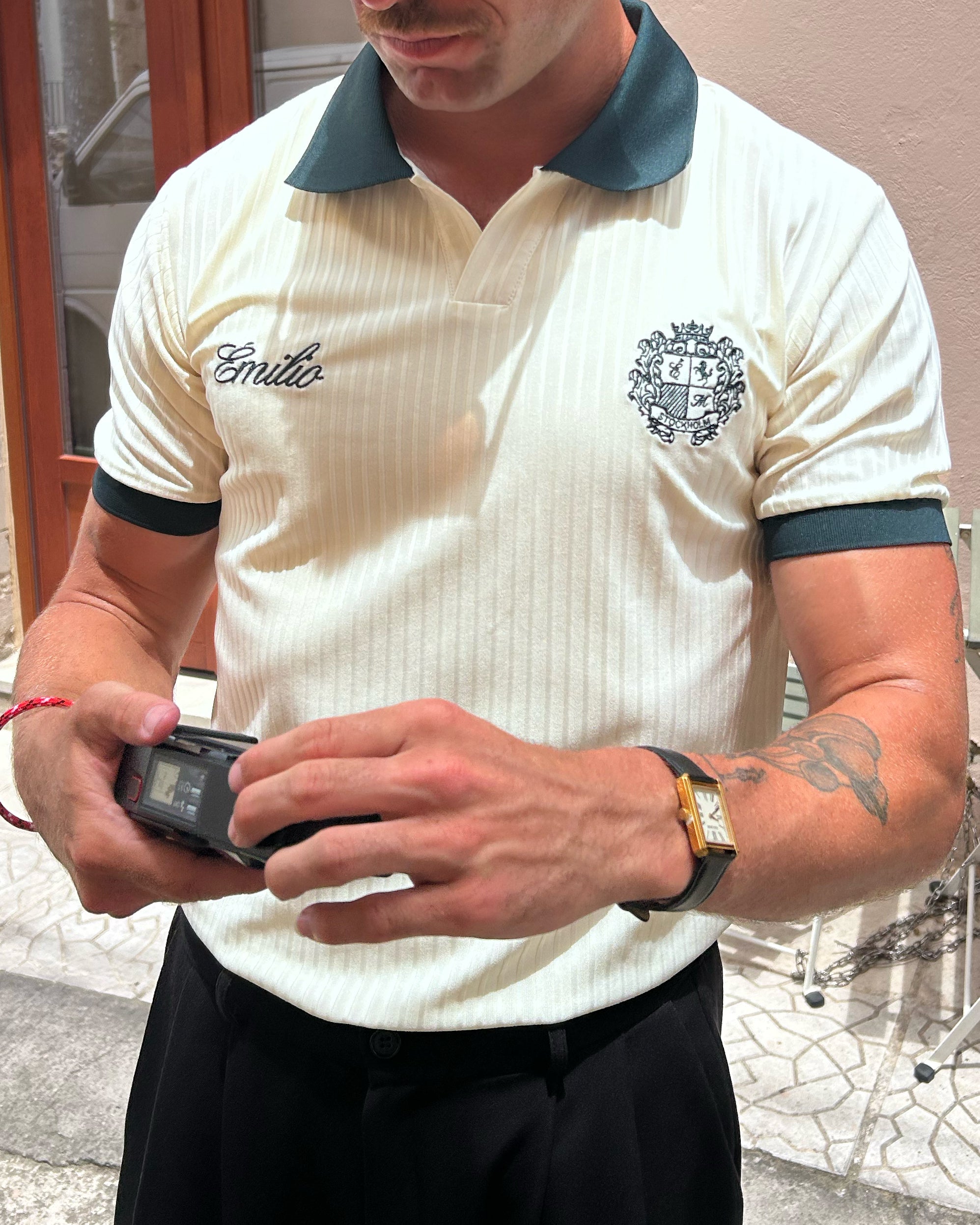 Man wearing a cream-colored émilio pique shirt with green trim 