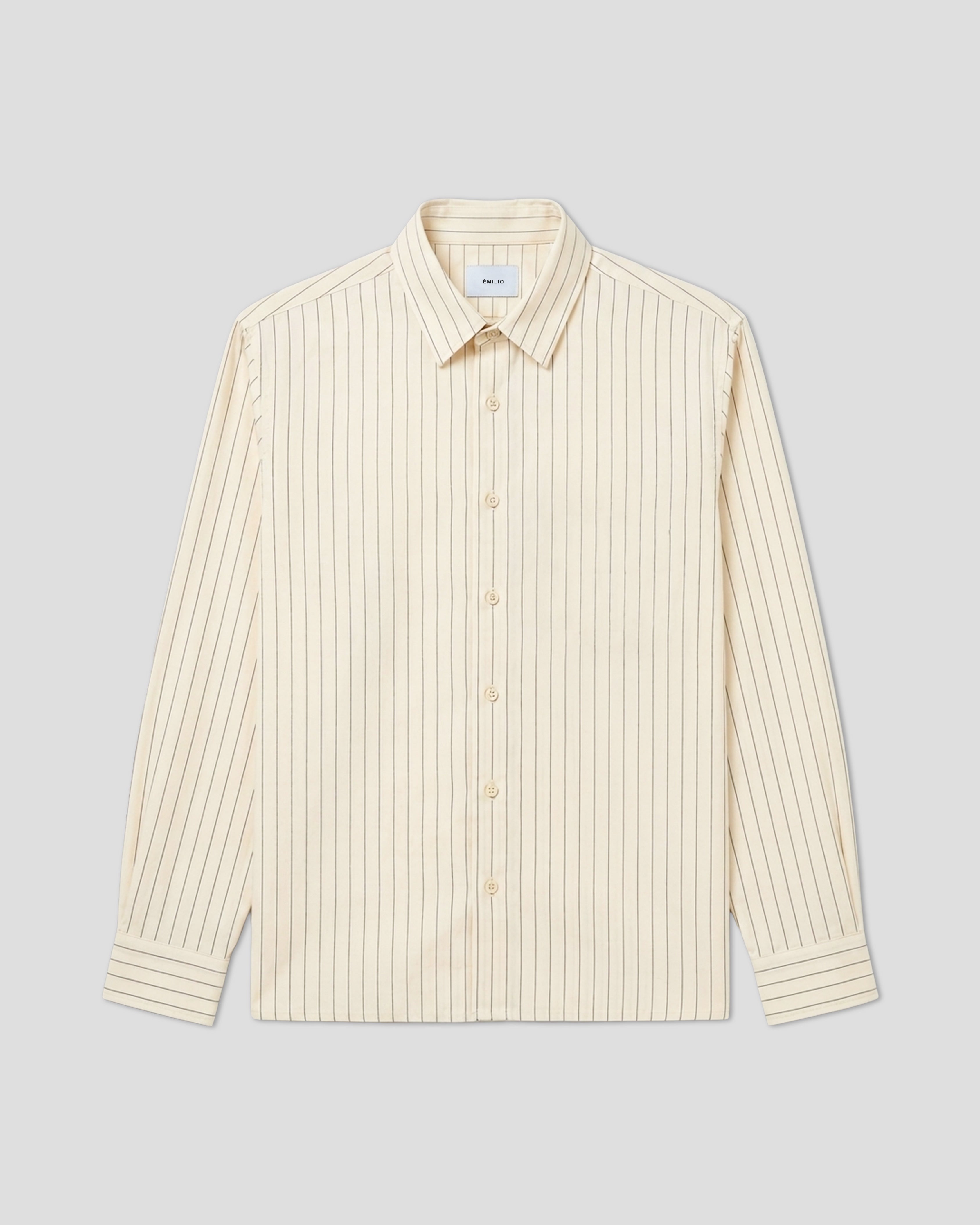 Cream pinstripe oversized shirt laid flat, showing white and cream stripe pattern. Émilio SS26